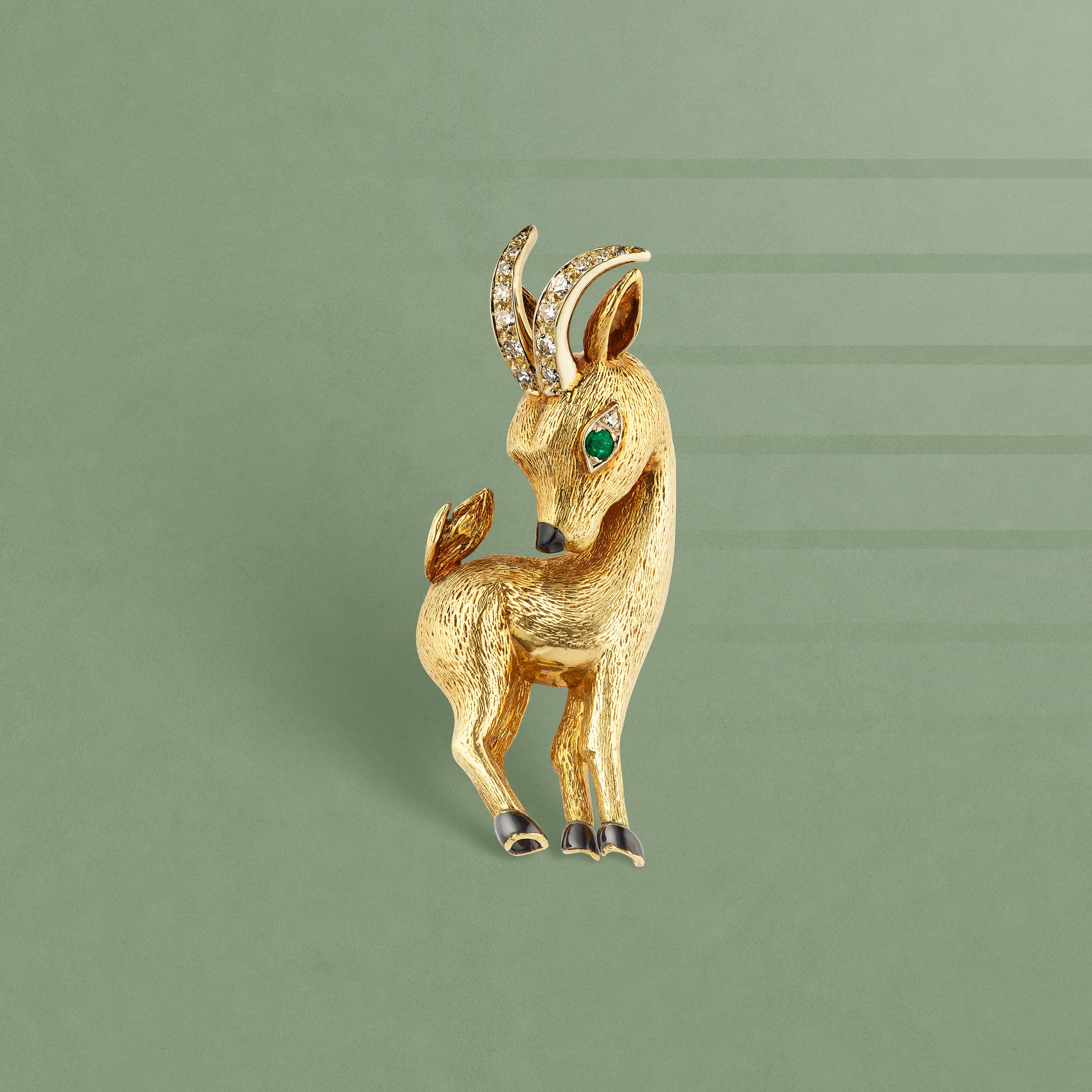 Capricorn clip, 1966. 18K yellow gold, 18K white gold, emerald, onyx, enamel, diamonds. Van Cleef & Arpels Collection.